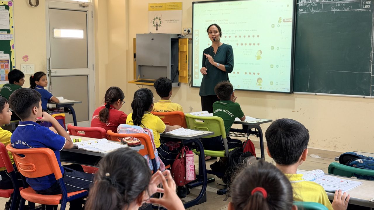 Teacher leading a lesson at the smart board